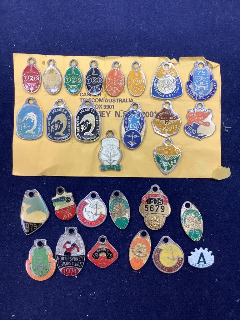 A collection of assorted enamel badges and nursing badges